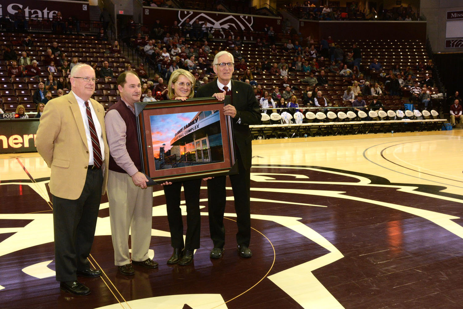 CLARKES’ COMPLEX
Missouri State University President Clif Smart, from left, and Athletics Director Kyle Moats on Jan. 12 present Krystyna and Dr. Michael Clarke with a plaque recognizing their naming rights gift. The men’s and women’s basketball locker rooms and team facilities at the campus arena are now called the Clarke Family Basketball Complex. The university has not announced a new name for the arena since the JQH signage was removed seven months ago.